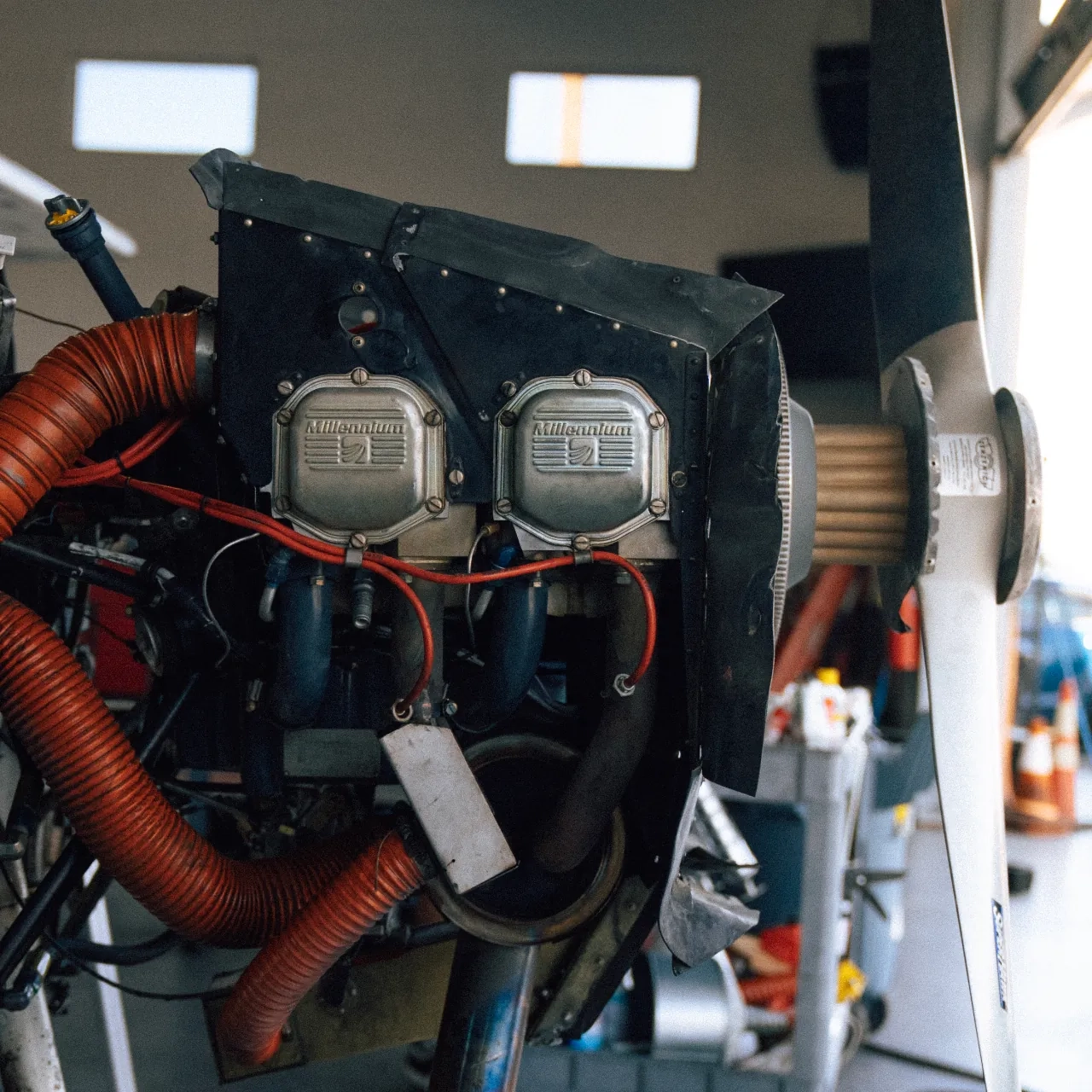 Uncowled engine and propeller of a SimpliFly Flight School aircraft during maintenance in the hangar