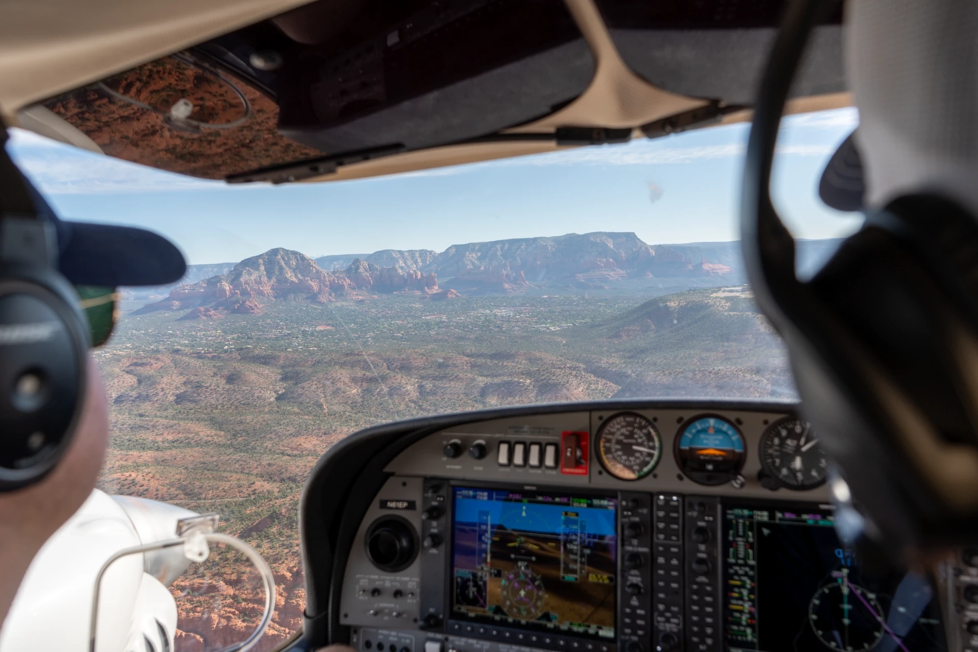 Pilot's view from a glass-cockpit Diamond airplane cruising over Arizona red-rock country