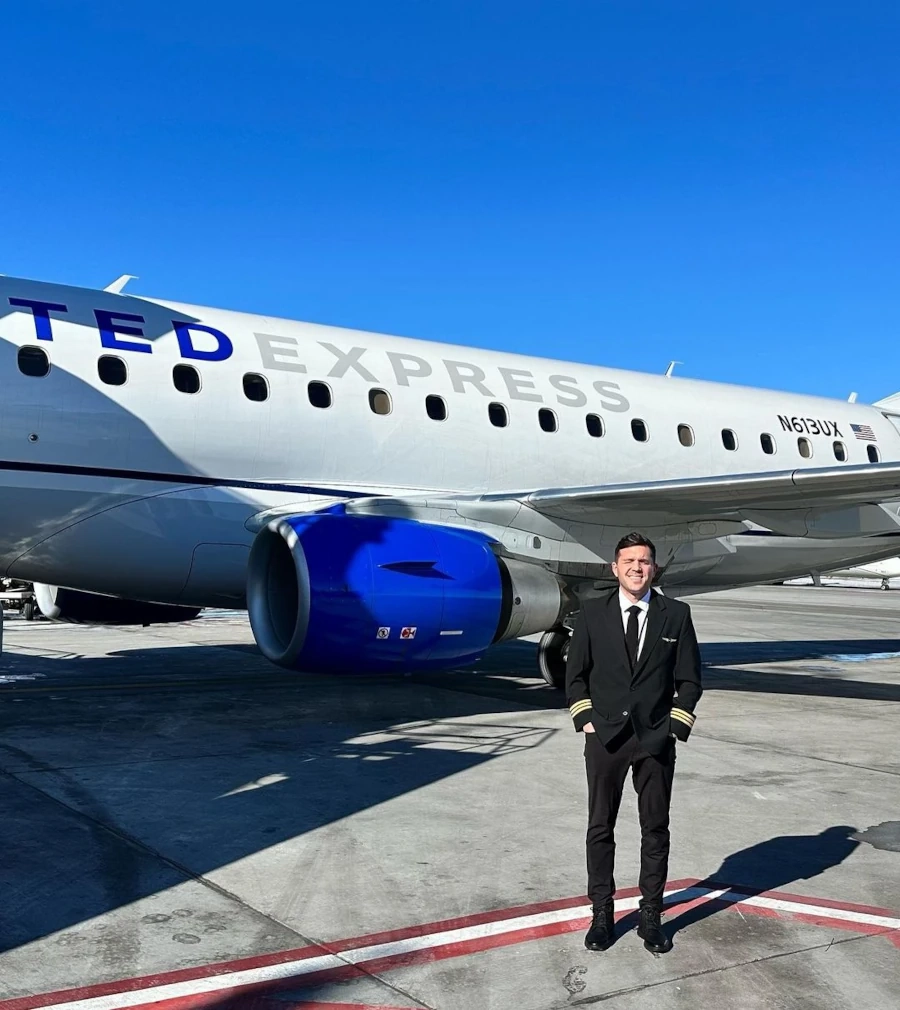 SimpliFly Flight School airline pilot next to a commercial airplane