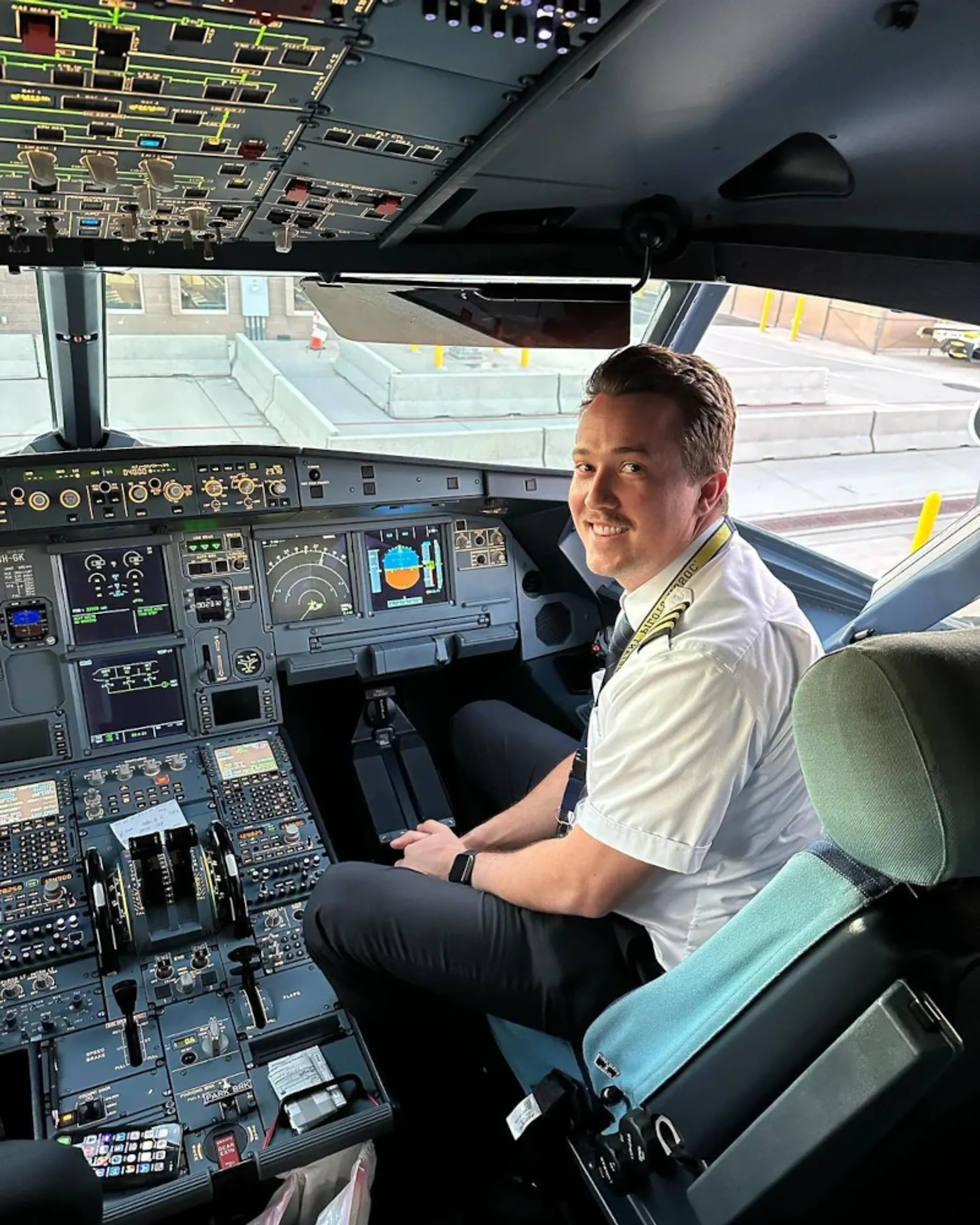 Airline pilot seated in a commercial aircraft flight deck