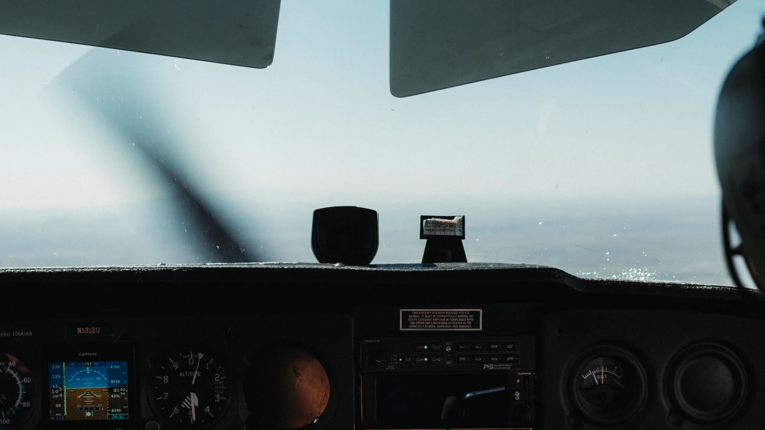 Cockpit view of instrument panel and front window during flight
