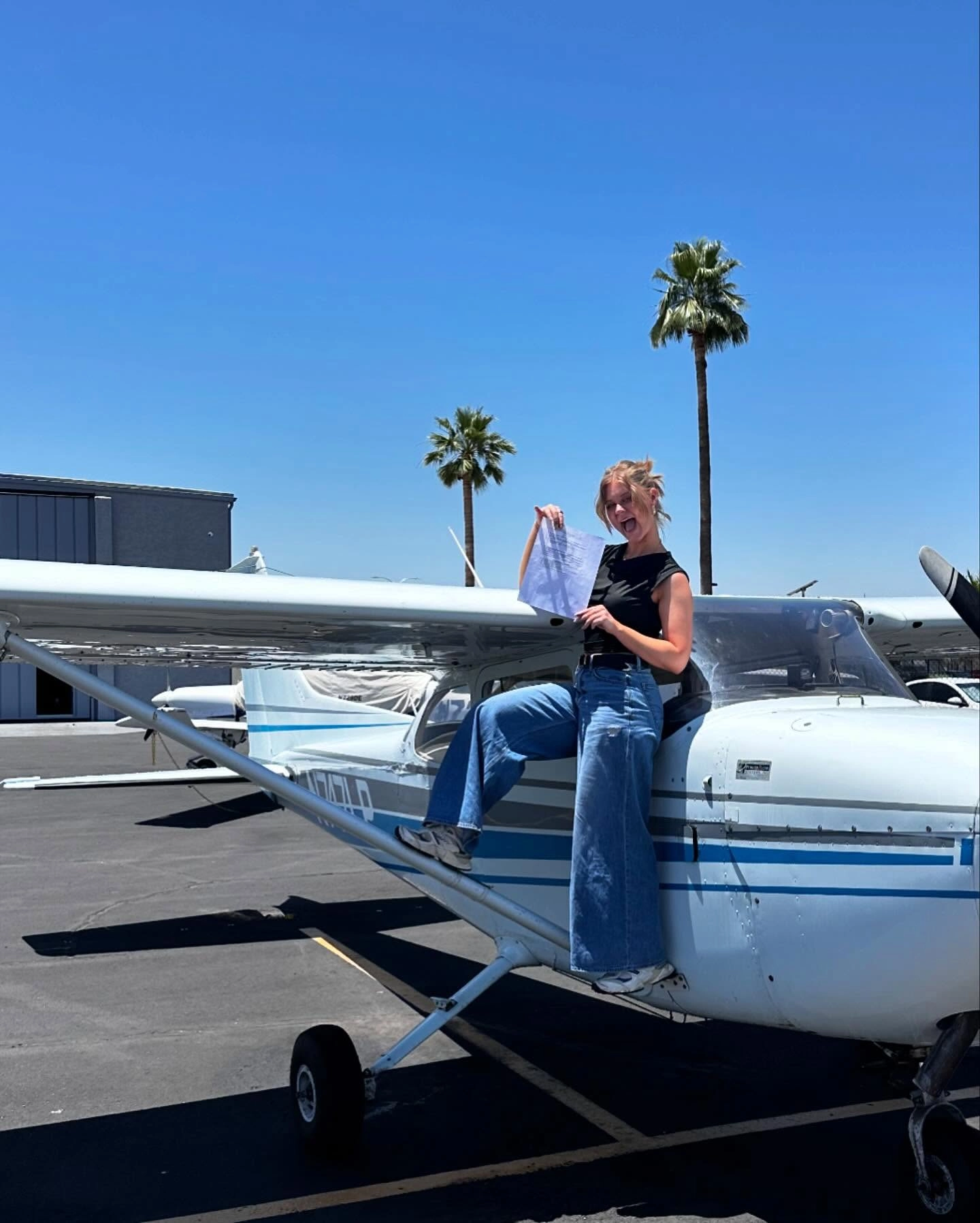 SimpliFly Flight School student smiling in front of an airplane