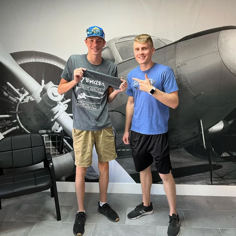 Student pilot at SimpliFly after soloing pictured with instructor