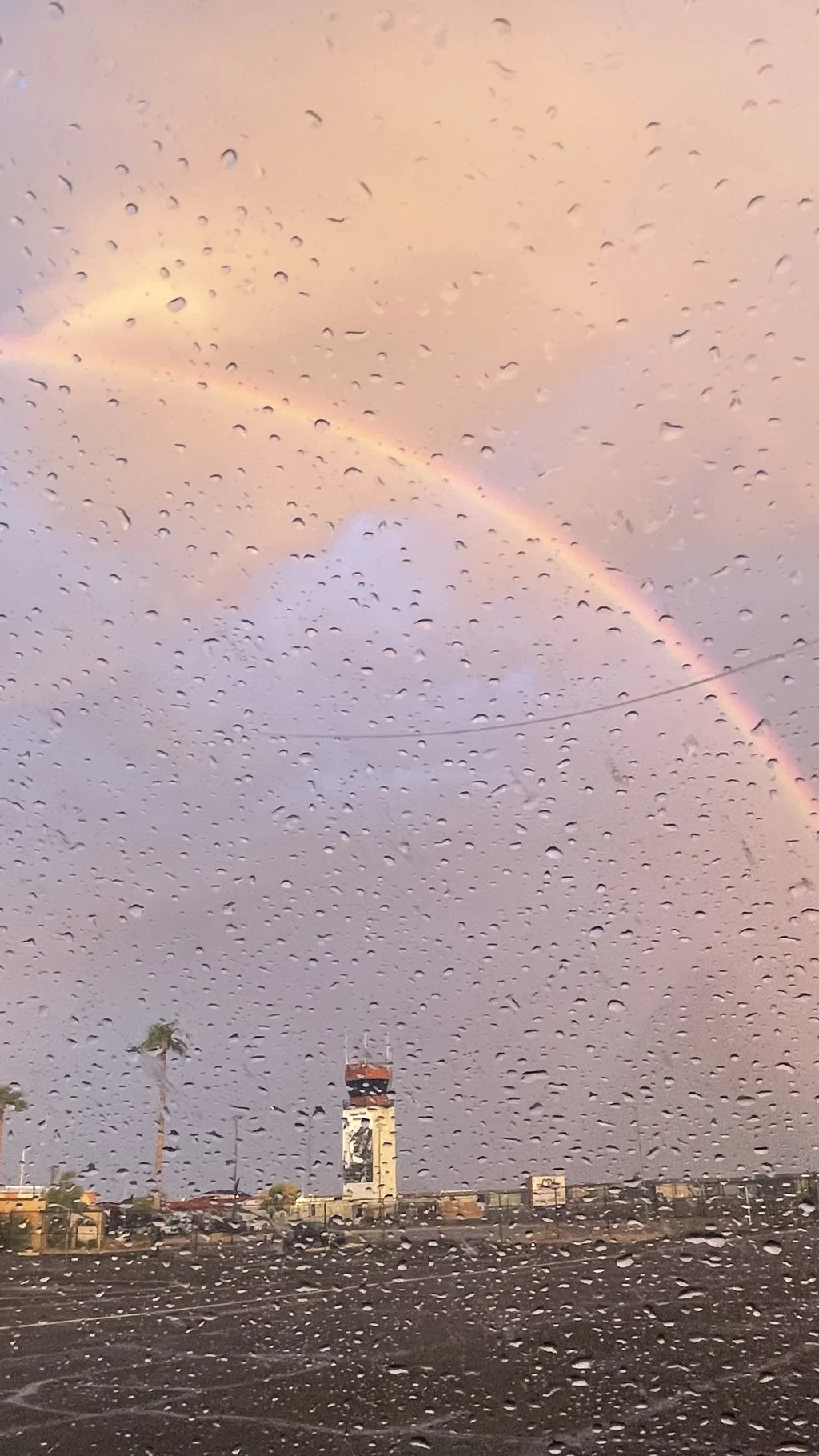 Rainbow and changing weather near an airport control tower in Arizona