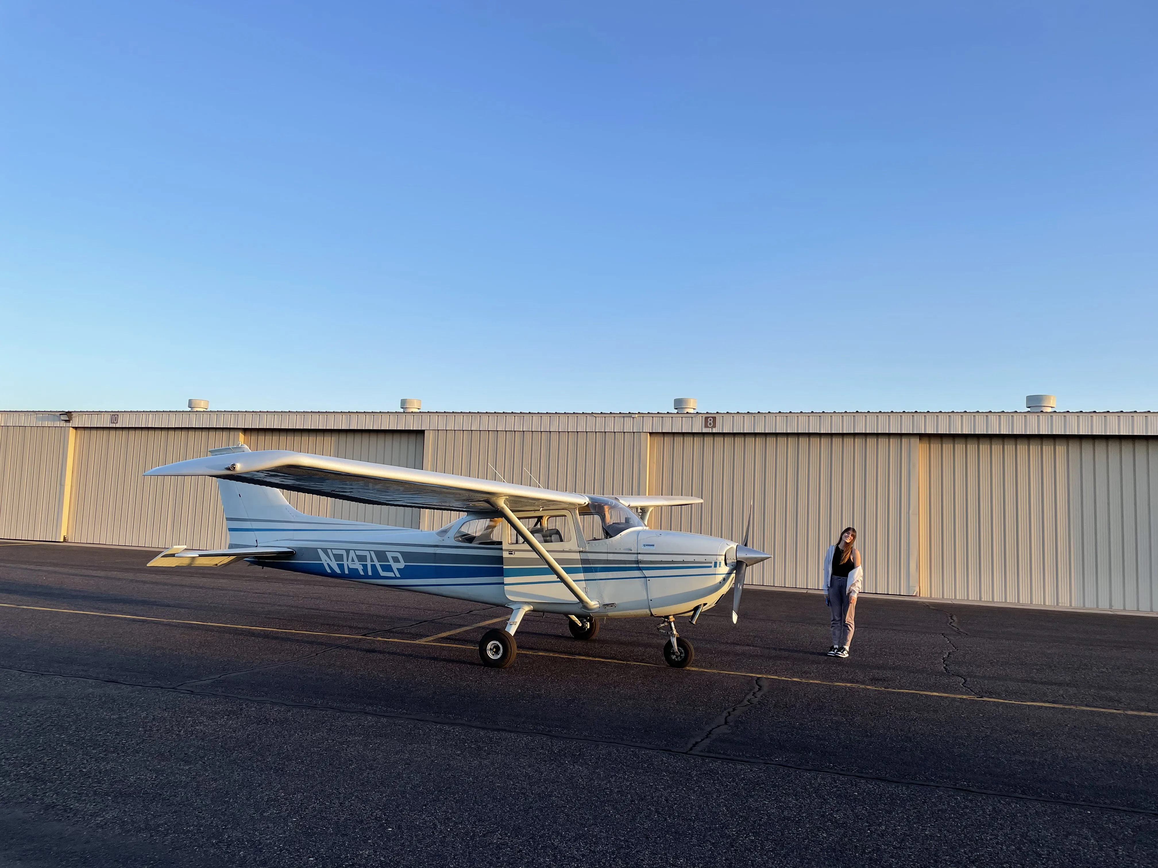 Cessna outside of a hangar with a student pilot at Falcon Field Airport (KFFZ)